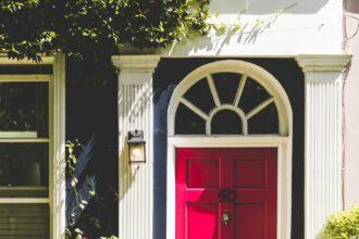 closed red door beside sconce