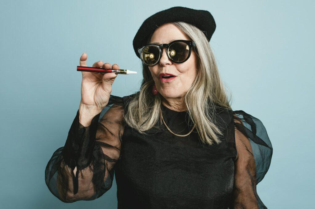 Senior woman smoking electronic cigarette