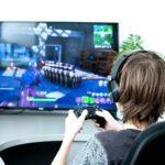 Teenager or young men play online video game. Gaming. Unrecognisable Gamer from back with joystick