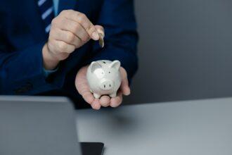 A person is holding a piggy bank, saving money and managing personal finances. Concept of increasing