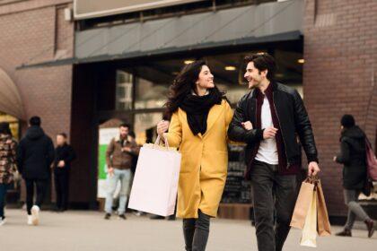 Consumerism concept. Couple shopping on weekend in mall