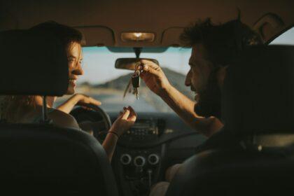 Couple exchanging car keys on a road trip