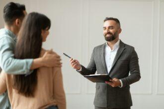 Estate Agent Showing Property For Young Buyers