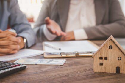 House signers signing signature loan document to home ownership with real estate agents ownership