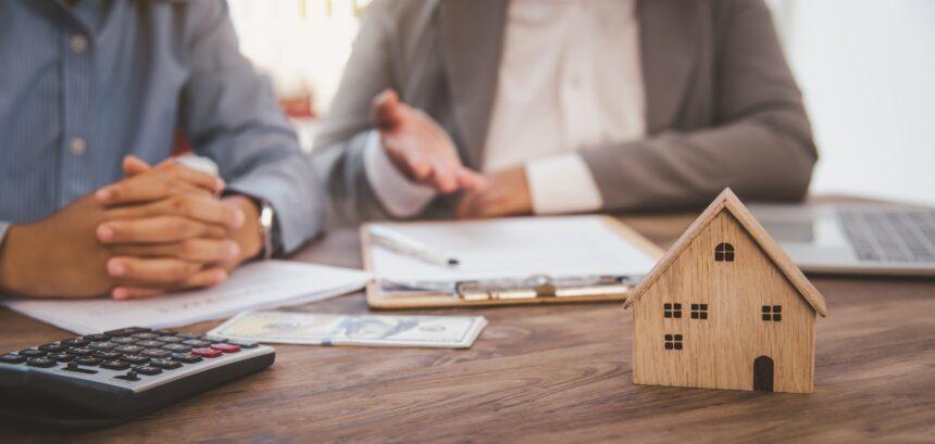 House signers signing signature loan document to home ownership with real estate agents ownership