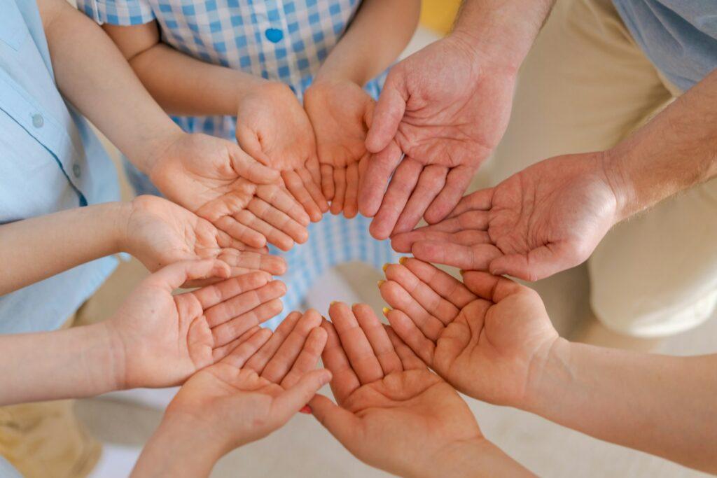 Large family holds palms their hands together, concept happiness in the family