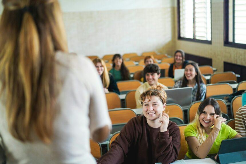 Mature teacher working with students inside classroom at school university