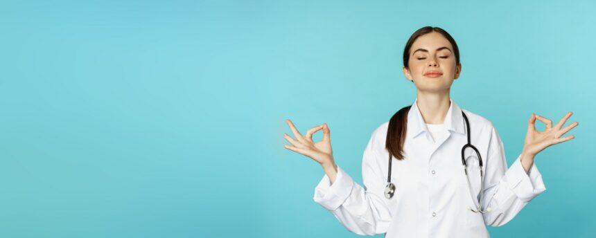 Mindfulness and meditation. Patient young woman doctor keep calm, hold hands in mudra, namaste