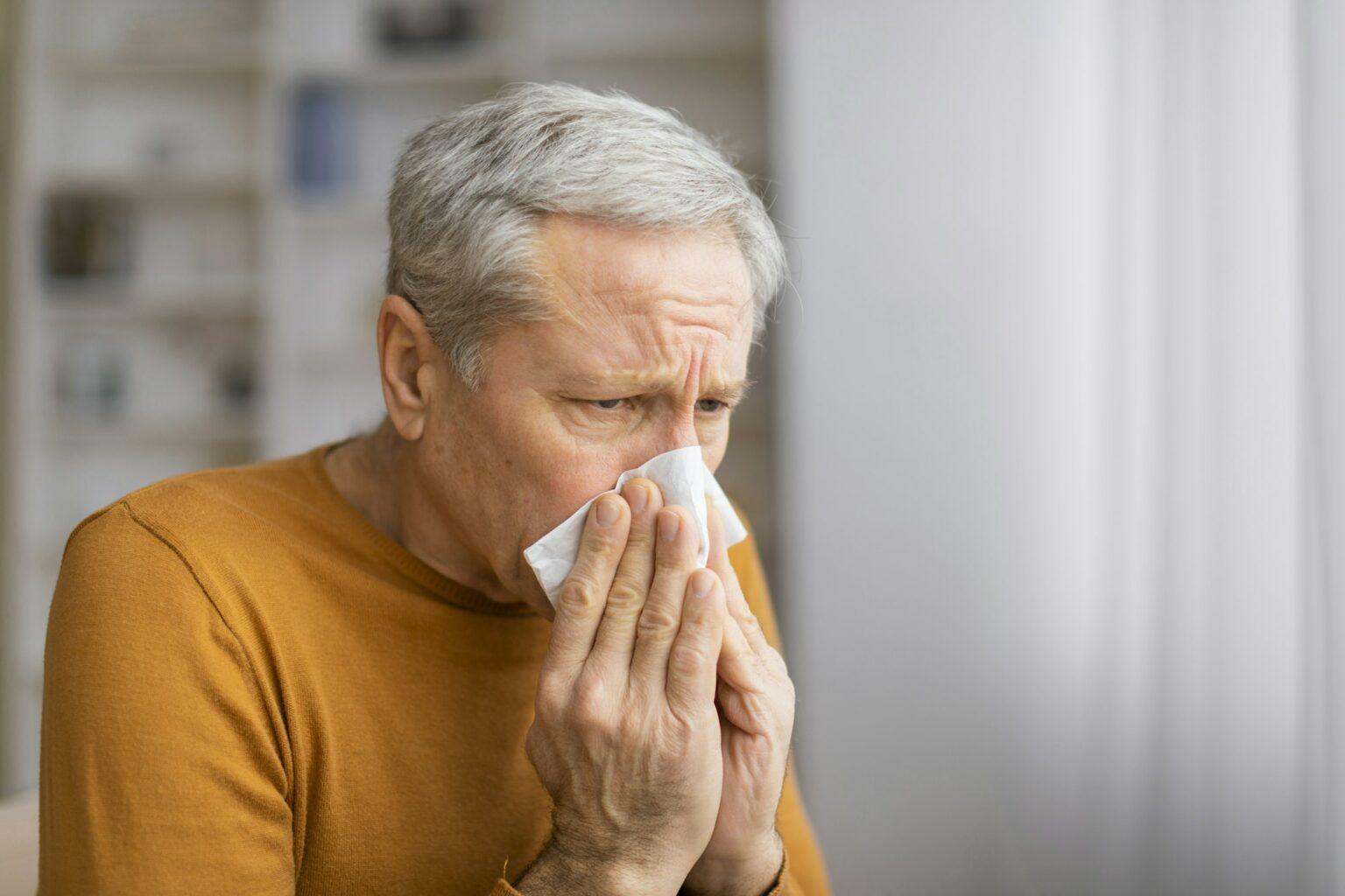 Senior man holding a blank square in front of face