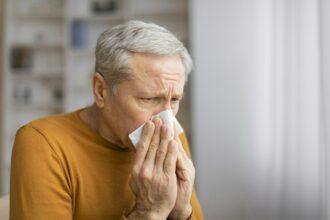 Senior man holding a blank square in front of face