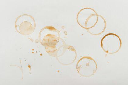 Top view of brown coffee stains on grey background