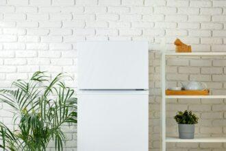 White Refrigerator In A Modern Kitchen With Brick Wall