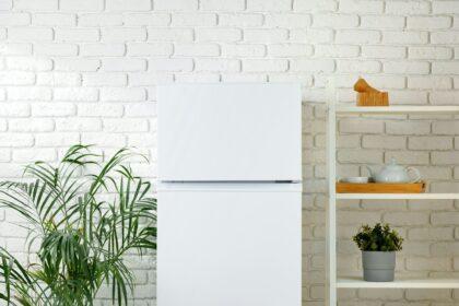 White Refrigerator In A Modern Kitchen With Brick Wall