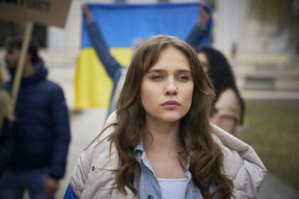 Young caucasian woman looking at camera on manifestation against war