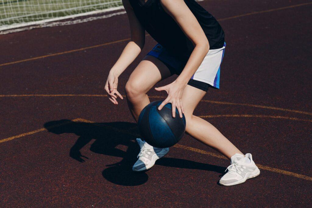 Young woman basketball player playing street ball