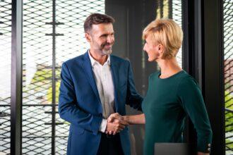 Business people shaking hands in the modern office finishing successful meeting