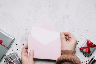 Female hands hold love letter message in envelope, Valentine's Day greeting card