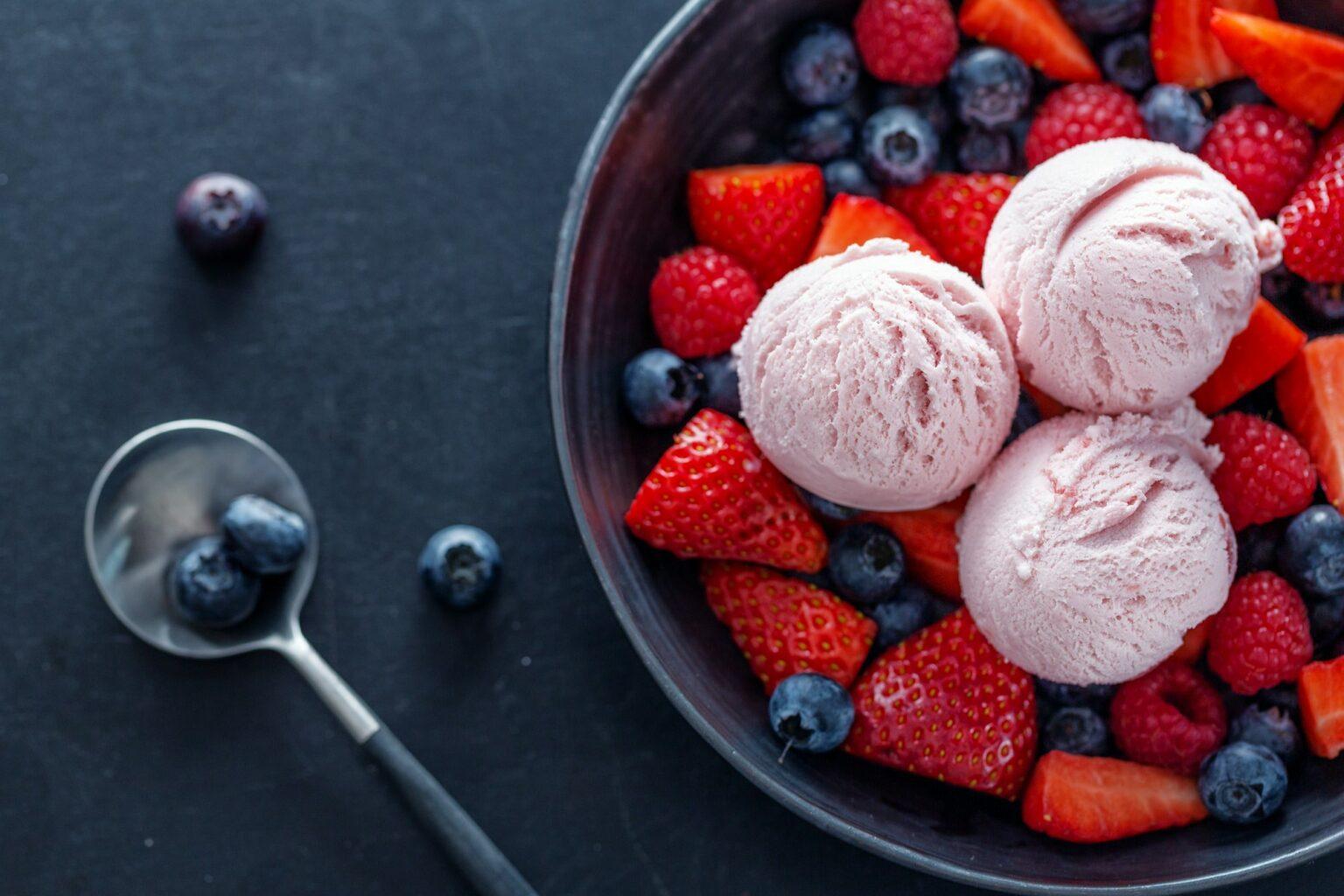 Fruity ice cream scoops on plate