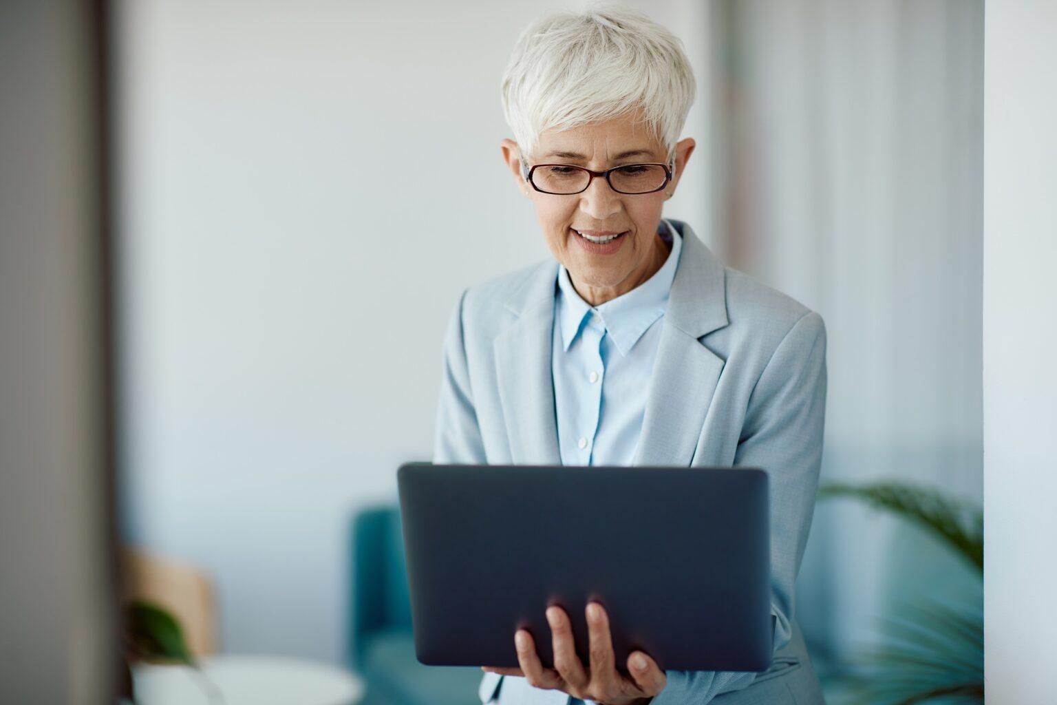 Senior businesswoman working on laptop in the office.