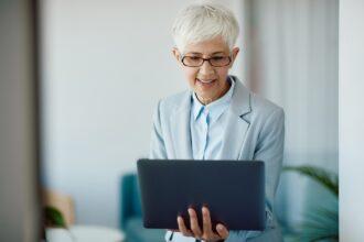 Senior businesswoman working on laptop in the office.