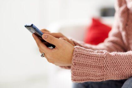 Asian Girl Reading Sms On Smarthphone