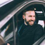 young bearded businessman sitting car