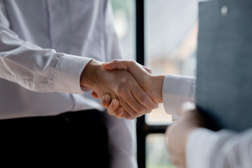 Business investor group holding hands.