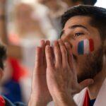 French football fans celebrating their team's victory at stadium.