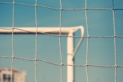 European football or soccer goal defocussed in background