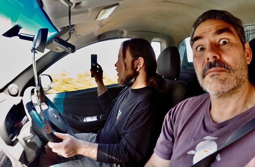 Father and son fun road trip filming while driving