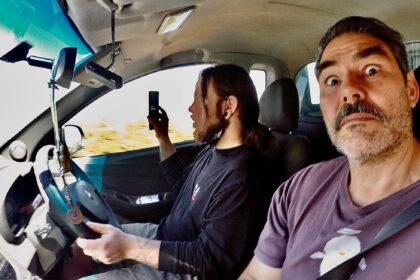 Father and son fun road trip filming while driving