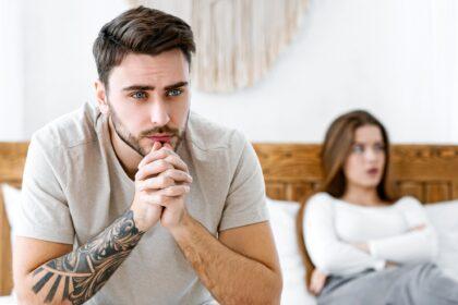 Impotence concept. Sad man presses hands to his chin and ponders
