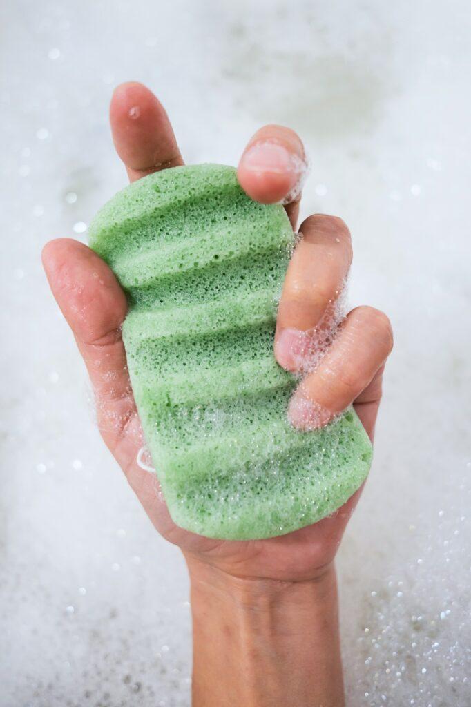 Konjac Sponge with Foam Bubbles in Female Hand, Close Up.