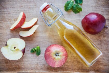 Natures detox. Overhead shot of a bottle of apple cider vinegar on a wooden table.