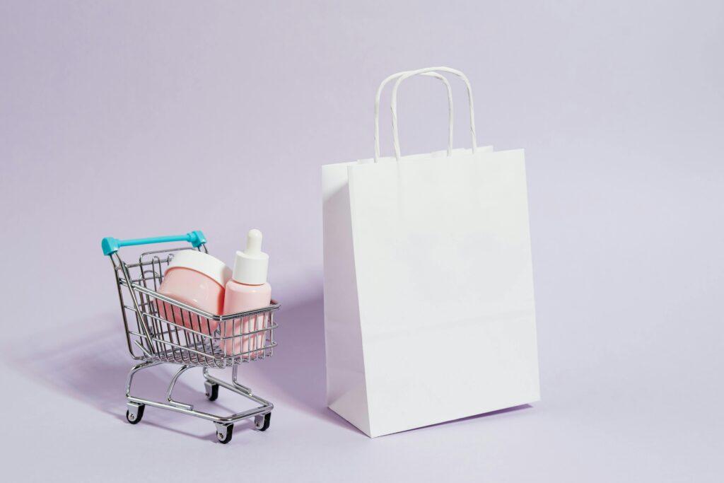 A minimalist image featuring a shopping cart with cosmetics and a white paper bag, ideal for Black Friday promotions.