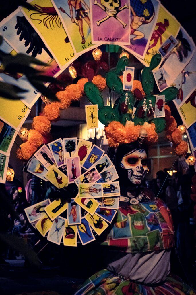 Colorful Día de Muertos celebration with traditional Catrina adorned with lotería cards in Tlaquepaque, Mexico.