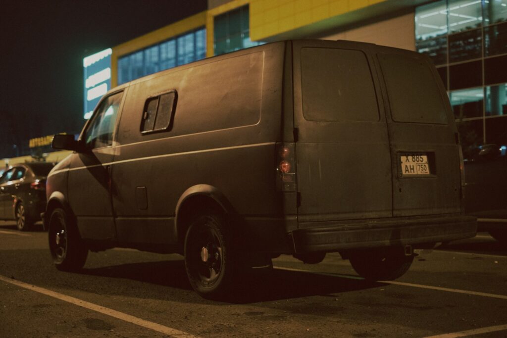 A van parked in a parking lot at night