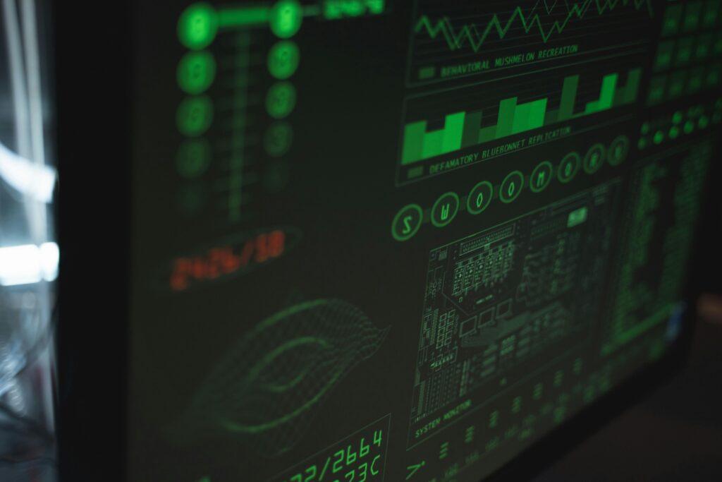 Close-up view of a computer displaying cybersecurity and data protection interfaces in green tones.